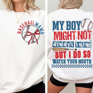 May include: White sweatshirt with baseball-themed graphics. The front features a baseball with a red bow and the text "Baseball Mama." The back displays the text "My Boy Might Not Always Swing But I Do So Watch Your Mouth" with baseball and bat graphics.