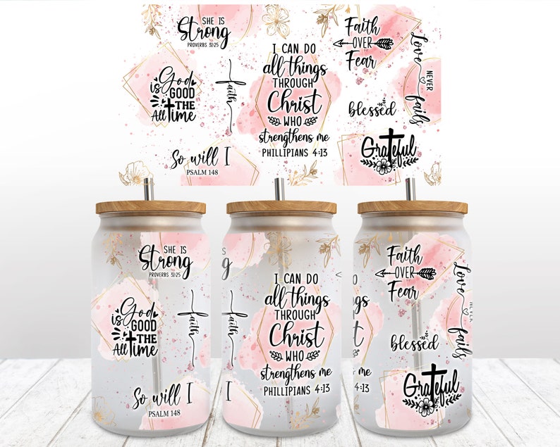 May include: Three clear glass tumblers with pink and gold watercolor designs and inspirational quotes. The quotes include "She is Strong", "I can do all things through Christ who strengthens me", and "Faith over Fear".