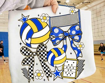 May include: White volleyball-themed design featuring a volleyball, a net, and a bow with volleyballs. The design includes stars, flowers, and a dominoes-like shape. The volleyballs are blue and yellow.
