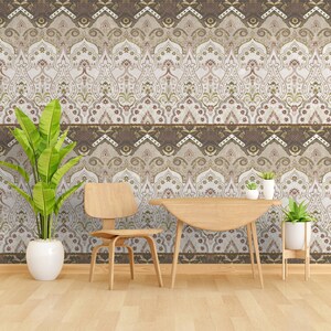 May include: A light wood dining table and chair set in front of a wall with a brown and white patterned wallpaper. The wallpaper features a repeating design of arches and floral motifs.
