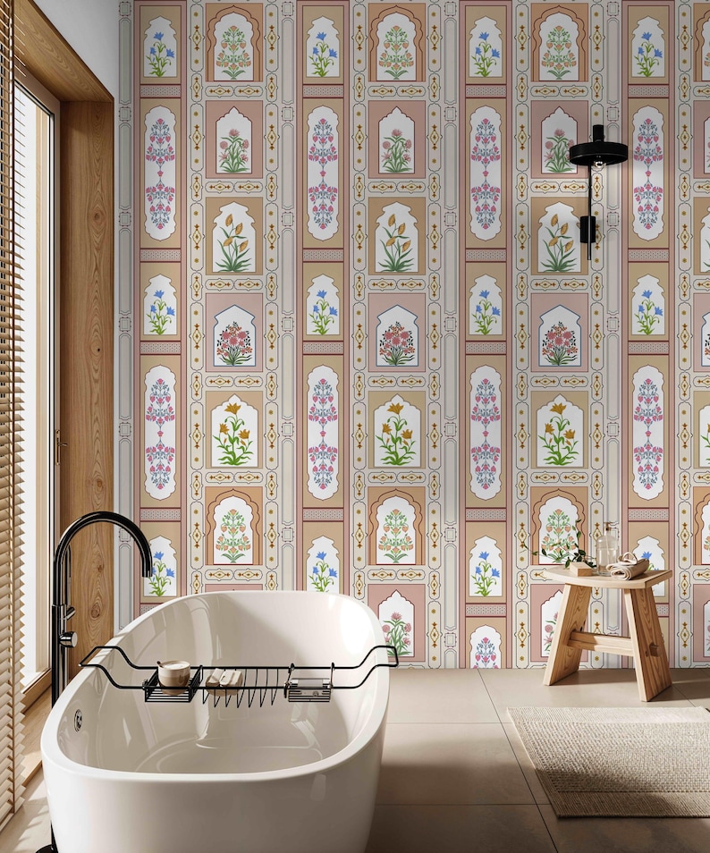 May include: A white bathtub with a black metal rack sits in a bathroom with a beige and pink patterned wallpaper featuring floral designs and arches. A wooden stool is in the foreground.