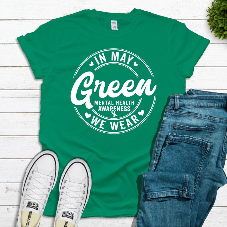 May include: Green t-shirt with a white circle graphic that says "In May We Wear Green" and "Mental Health Awareness".
