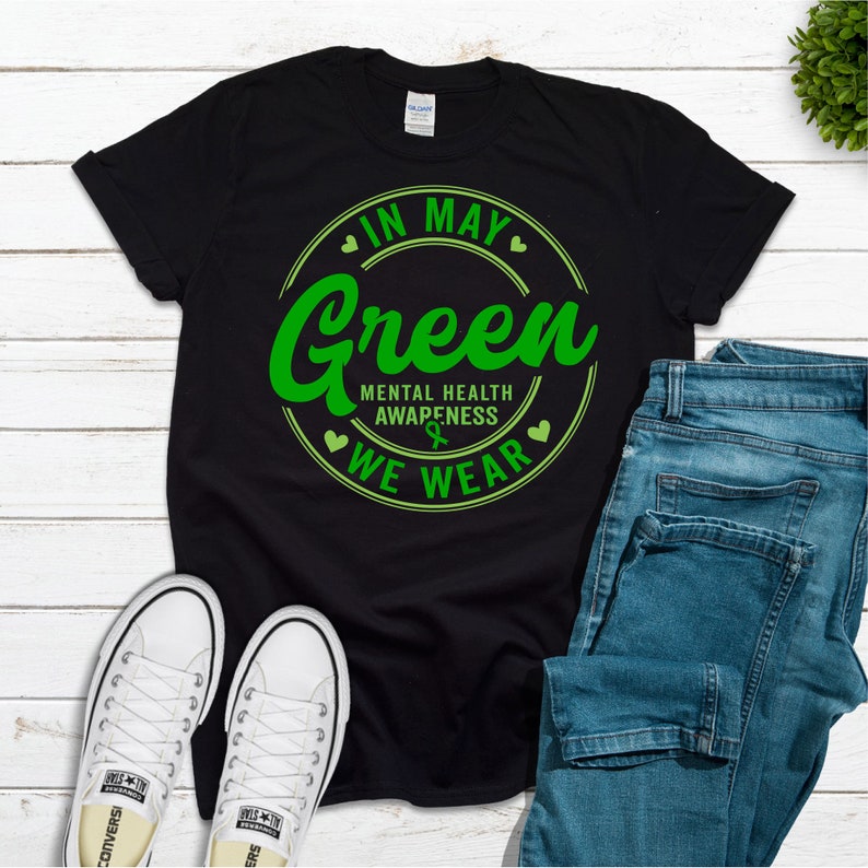 May include: Black t-shirt with a green circle graphic that says "In May We Wear Green" and "Mental Health Awareness".