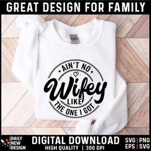 May include: White sweatshirt with a black circle graphic that says "Ain't No Wife Like The One I Got" with a small heart in the center of the circle.