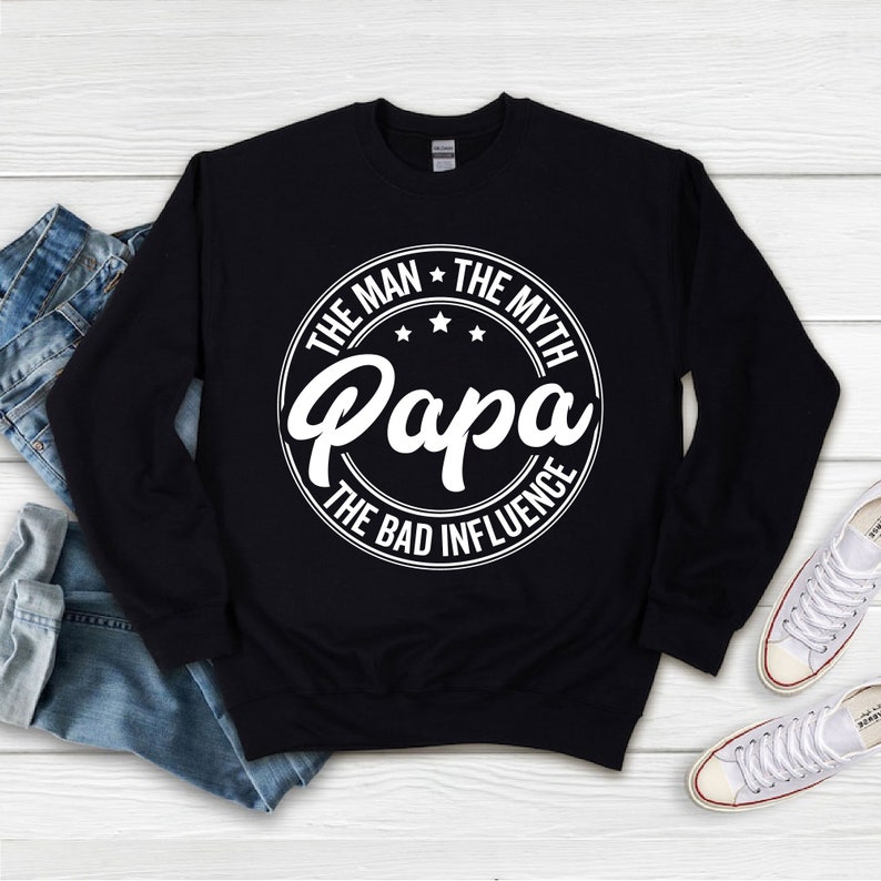 May include: Black sweatshirt with a white circle graphic that says "The Man * The Myth * Papa * The Bad Influence".
