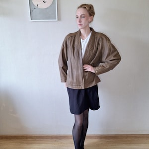 Vintage 1990s oversized leather jacket with geometrical texture in khaki green