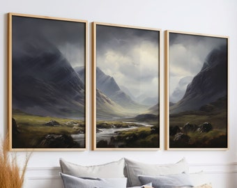 May include: A set of three framed landscape prints featuring a misty mountain valley scene with a river winding through it. The prints are in a light wood frame and are hung on a white wall.