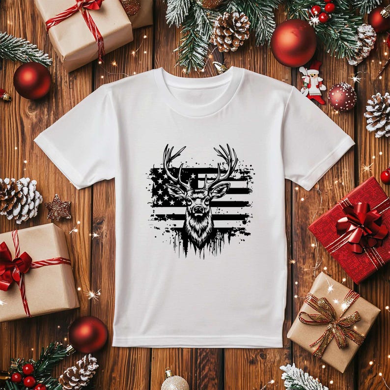 May include: White t-shirt with a black and white graphic of a deer's head in front of an American flag.