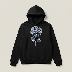 May include: Black hoodie with a large blue rose graphic on the front. The rose is detailed with a denim-like texture and features a hood and a front pocket. A casual, comfortable style.