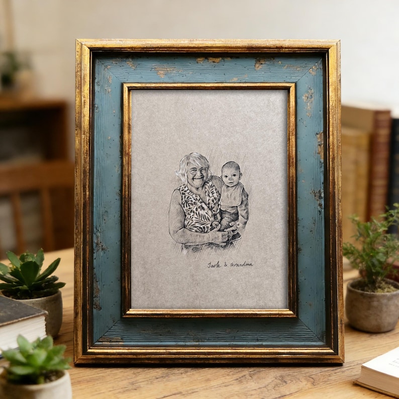 May include: A rectangular picture frame with a distressed teal and gold finish. The frame holds a black and white sketch of a woman and a baby. The text "Jack & grandma" is written below the sketch.