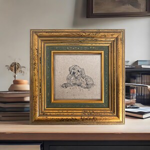 May include: Square framed print featuring a detailed sketch of a dog lying down. The frame has a distressed gold finish with a green inner border. The artwork is set against a neutral background, creating a classic and elegant aesthetic.