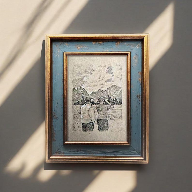 May include: A framed pencil sketch of two people looking at a mountain range. The frame has a distressed blue outer edge and a gold inner edge. The artwork depicts a landscape with trees and mountains.