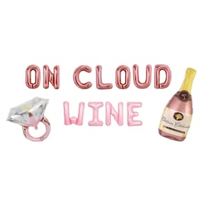 May include: Pink and rose gold foil balloons spelling "ON CLOUD WINE", with a diamond ring balloon and a champagne bottle balloon. Perfect for a bridal shower or bachelorette party.