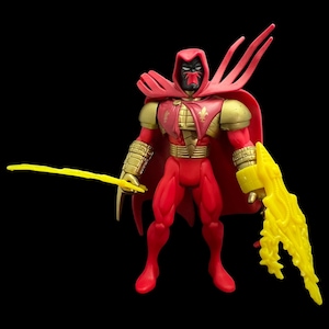 May include: A red action figure of a masked superhero with a red hood and cape, gold accents, and yellow energy weapons. The figure is posed against a black background.