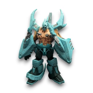 May include: A detailed action figure of a cyborg warrior. The figure has a muscular torso with battle scars and is clad in teal armour with black accents. The figure has large shoulder-mounted blades and detailed mechanical components.