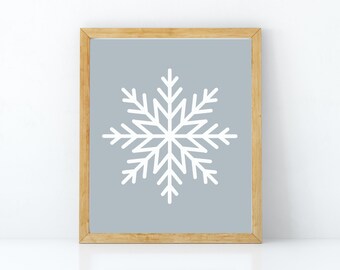 Könnte beinhalten: Ein gerahmter Druck mit einem weißen Schneeflocken-Design auf hellblauem Hintergrund. Der Rahmen ist aus Naturholz.