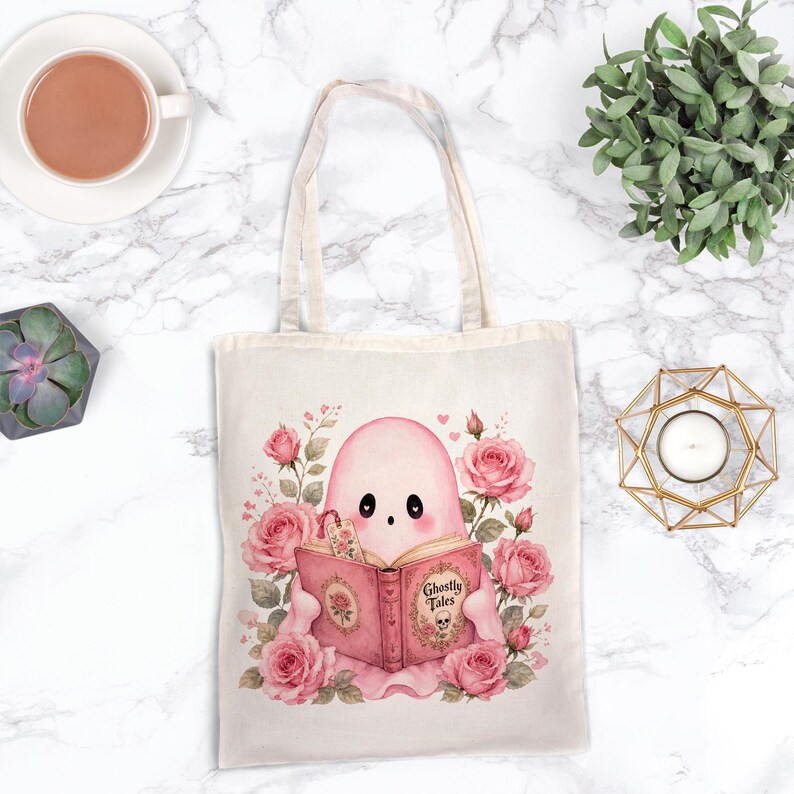 Pink ghost reading book design on tote bag. Cute bookish coquette Halloween ghost with flowers, sublimation PNG.
