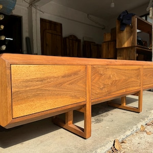 Handmade solid walnut TV stand with wooden legs, front view showing natural wood texture