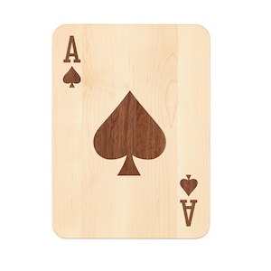 May include: A wooden Ace of Spades playing card. The card has a light wood grain background with a large, dark spade symbol in the centre. The letter "A" and a smaller spade are in the upper left and lower right corners.