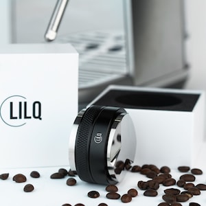 May include: A white ceramic mug with a black handle and the text "But First, Coffee" in a black, bold font. The mug is likely 4 inches tall and holds approximately 12 ounces of liquid.