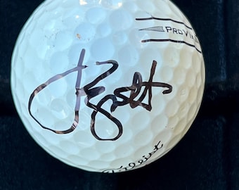Pelota de golf firmada por Jordan Spieth con certificado de autenticidad.