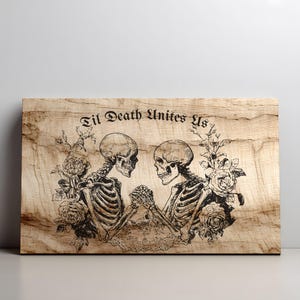 May include: A rectangular wooden plaque featuring a black laser-engraved illustration of two skeletons holding hands, surrounded by rose floral arrangements. The text "Til Death Unites Us" is engraved in a gothic font above the skeletons.