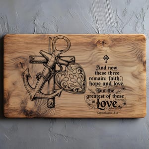 May include: Wooden cutting board with an engraved design featuring an anchor, cross, and heart. The text reads "And now these three remain: faith, hope and love. But the greatest of these is Love." from Corinthians 13:13.