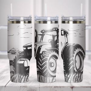 May include: Three stainless steel tumblers with a black and white illustration of a tractor. The tumblers have a white lid and a white handle.