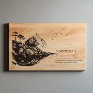 May include: Wooden wall art with a black and white illustration of a Norwegian cabin on a rocky shore, with a mountain backdrop and the word "NORWEGIAN". The art includes a definition and a quote about the Norwegian soul.