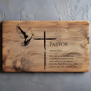 May include: Wooden cutting board with the word "PASTOR" and a definition, a cross, and a dove illustration. The definition includes the roles of a pastor. The board has a natural wood grain.