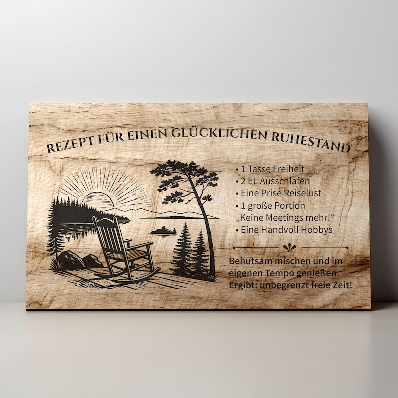 May include: A rectangular wooden sign with a light brown wood grain texture. It features a black laser-engraved illustration of a rocking chair by a lake at sunrise, alongside German text listing a recipe for a happy retirement.