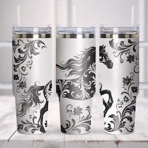 May include: Three stainless steel tumblers with a black and white design of a horse with floral accents. The tumblers have a handle and a lid.