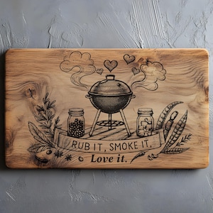 May include: Rectangular wooden chopping board with a barbecue grill design. The board features a grill, jars, and the text "RUB IT, SMOKE IT, Love it." Decorative elements include hearts and smoke. The board is made of light-coloured wood.