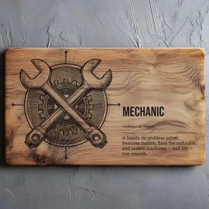 May include: A wooden chopping board with a mechanic theme. It features crossed spanners over a gear, with the word "MECHANIC" and a definition. The board is rectangular with a natural wood grain.