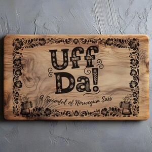 May include: Wooden rectangular cutting board with the text "Uff Da!" in black, surrounded by a floral border. The phrase "A Spoonful of Norwegian Sass" is below the main text. Two small figures play accordions.