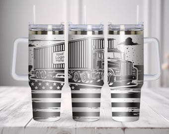 May include: A stainless steel tumbler with a handle, a clear lid, and a straw. The exterior features a black and white graphic of a semi-truck pulling a trailer with the text Your Logo Here, set against a background of a stylized American flag.