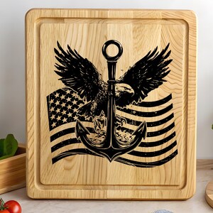 May include: A wooden cutting board with a black and white design of an eagle holding an anchor over an American flag.