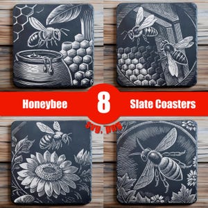 May include: Set of eight black slate coasters featuring a black and white engraved design of honeybees and honeycomb. The coasters are perfect for adding a touch of nature to your home decor.