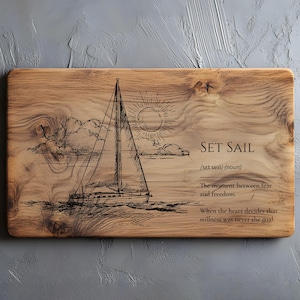 May include: Wooden serving board with a sailboat illustration, sun, and clouds. The text "SET SAIL" is above the definition and a quote about fear and freedom.