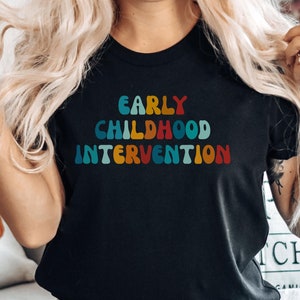 May include: A black t-shirt with the text "EARLY CHILDHOOD INTERVENTION" in rainbow colors.