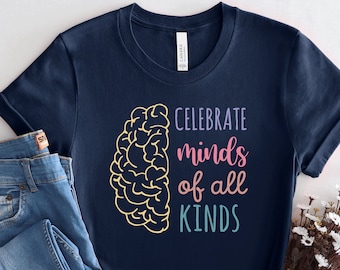 May include: A navy blue t-shirt with a brain graphic and the text "Celebrate minds of all kinds" in colorful lettering.