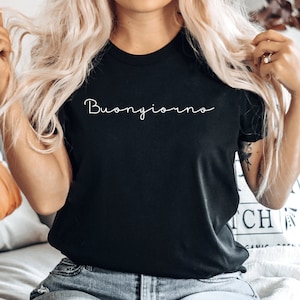 May include: A black t-shirt with the text "Buongiorno" written in white cursive script.