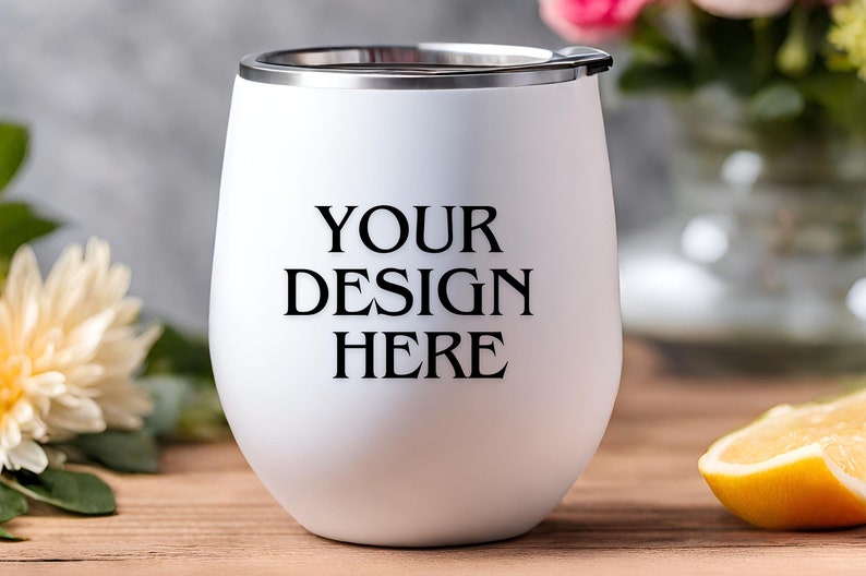 Peut inclure: Un gobelet &agrave; vin en acier inoxydable blanc avec un couvercle argent&eacute;. Le gobelet porte l'inscription "YOUR DESIGN HERE" imprim&eacute;e sur le devant.
