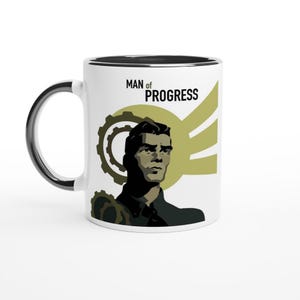 May include: White ceramic mug with a black rim and handle. The mug features a black and white illustration of a man with a serious expression. The text "MAN of PROGRESS" is printed in black on the mug.