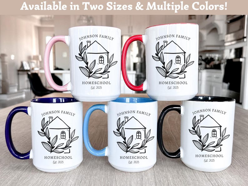 May include: White ceramic mugs with colored handles and interior rims. Each mug features a black illustration of a house with the text "JOHNSON FAMILY HOMESCHOOL Est. 2025". Handle colors include pink, red, blue, light blue, and black.