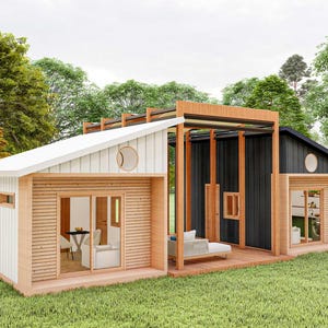 May include: A modern cabin featuring a split design with a white section and a black section, connected by a wooden pergola structure. The exterior includes sliding glass doors, circular windows, and horizontal wood siding accents on a grassy lawn.