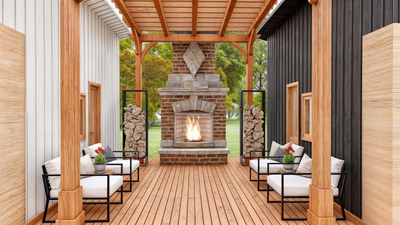 May include: An outdoor patio space featuring a wooden pergola, a central brick fireplace with a burning fire, and two black metal racks filled with stacked firewood. Four white cushioned chairs with black frames are arranged on the wooden deck.