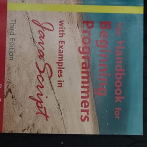 May include: A book titled "The Handbook for Beginning Programmers" with "Java Script" in red script. The cover has a blue and tan color scheme with the author's name, Rex Barzee, and "Third Edition" visible.