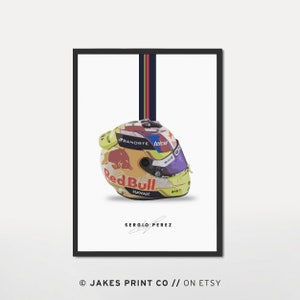 May include: A yellow, red, blue, and white racing helmet with a Red Bull logo and the signature of Sergio Perez. The helmet is on a white background with a blue and red stripe.