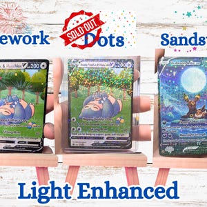 May include: Three rectangular trading cards featuring Pok&eacute;mon characters. The first card shows Snorlax and Munchlax with the text Happy Father's Day. The second card is in a clear case. The third card shows Umbreon and Eevee under a full moon.